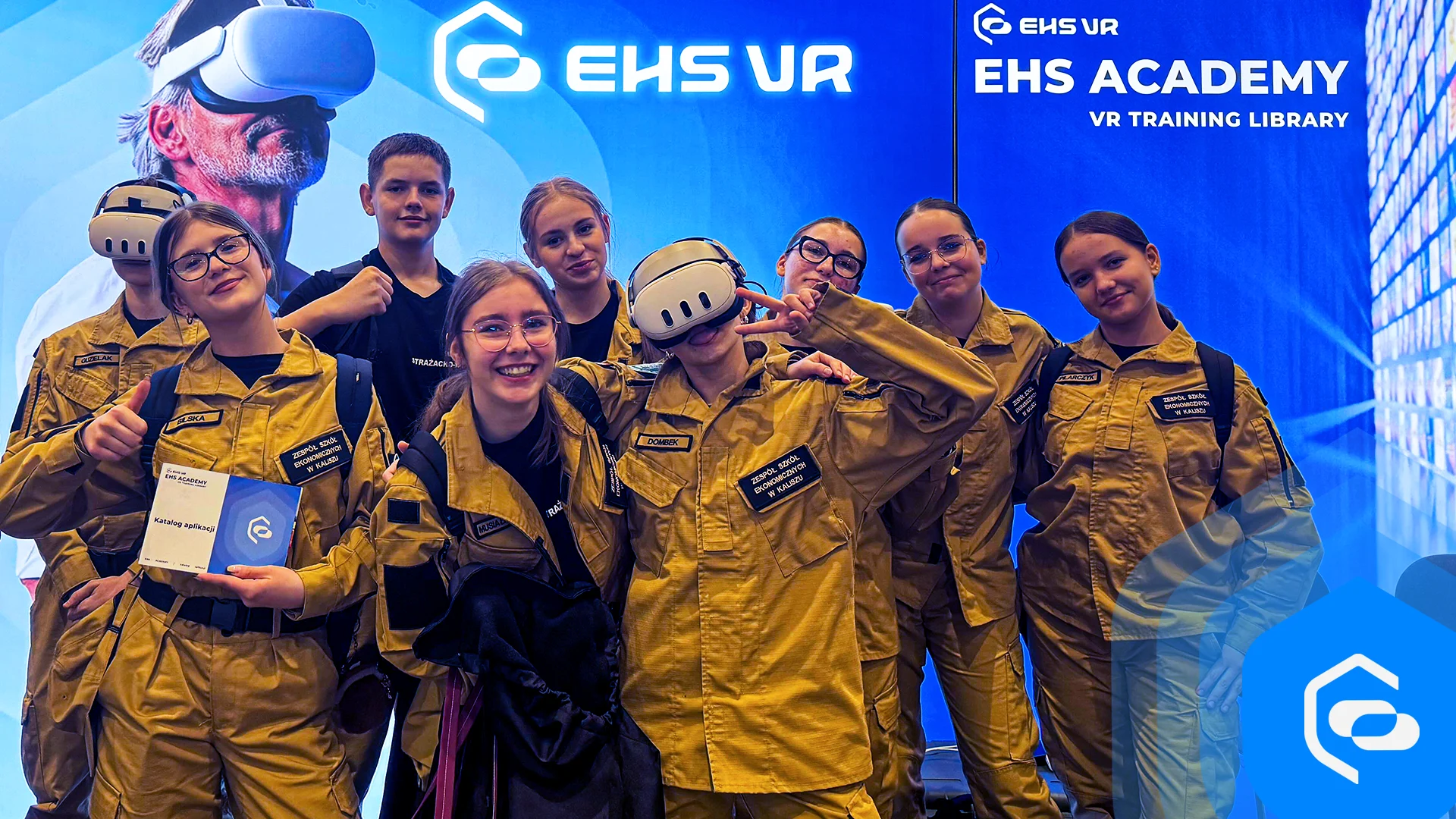 Group of young cadets in fire service uniforms at the EHS VR stand, some wearing VR headsets